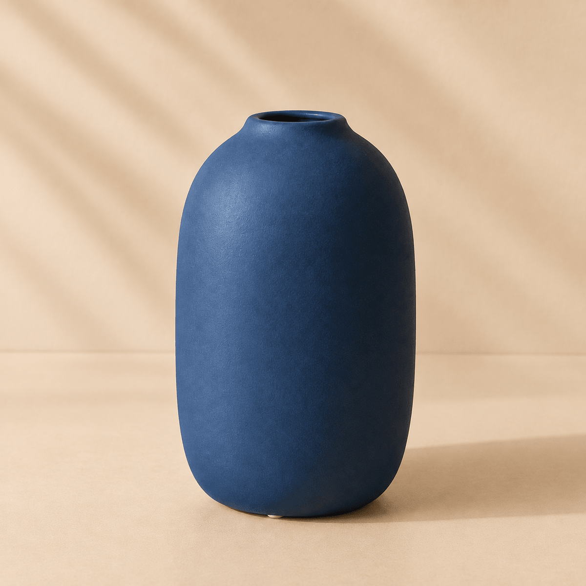 Solvi - Decorative Ceramic Vase — Blue in a clean warm-neutral product setting